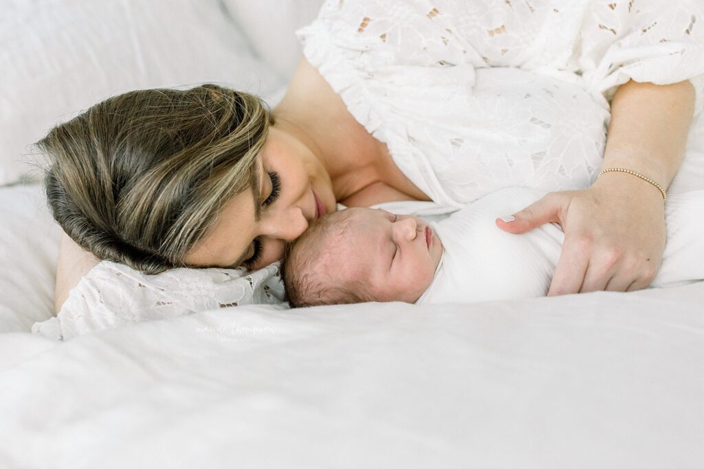 Mom and baby snuggling during in-home session in Katy, Texas