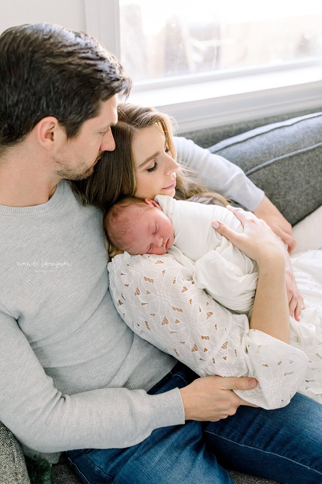 Mom and newborn baby sharing a tender cuddle in their Katy, Texas home