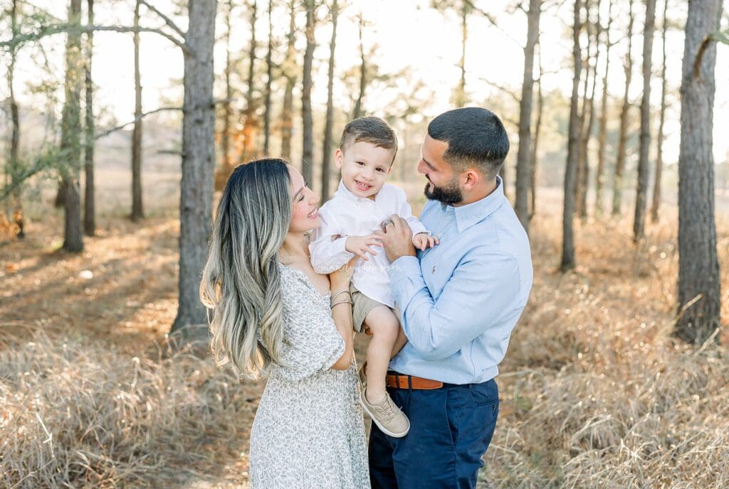Golden hour family portraits in Katy, TX showcasing luxury lifestyle photography with children and parents laughing together.