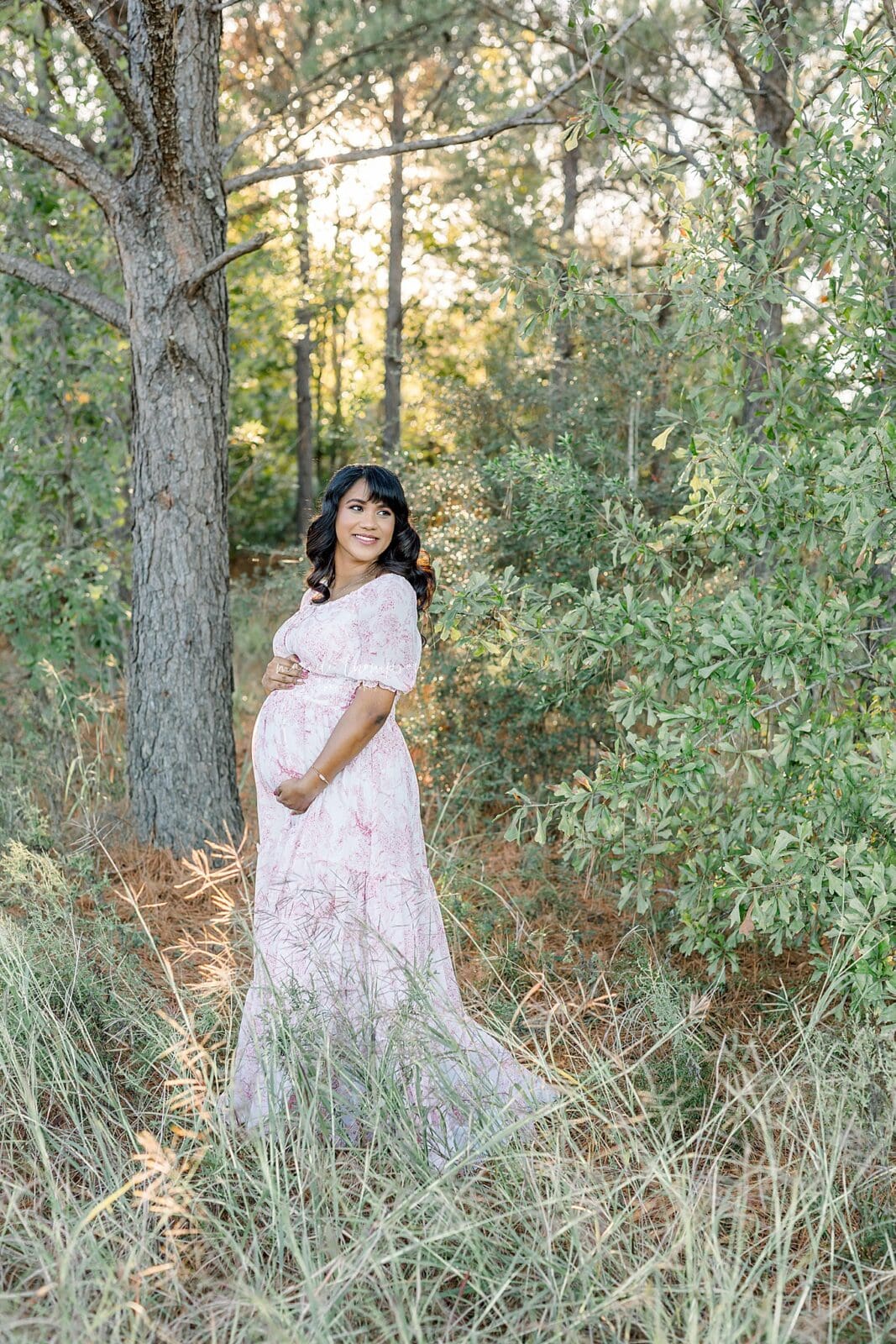 expecting mother smiles at her partner during her outdoor maternity session