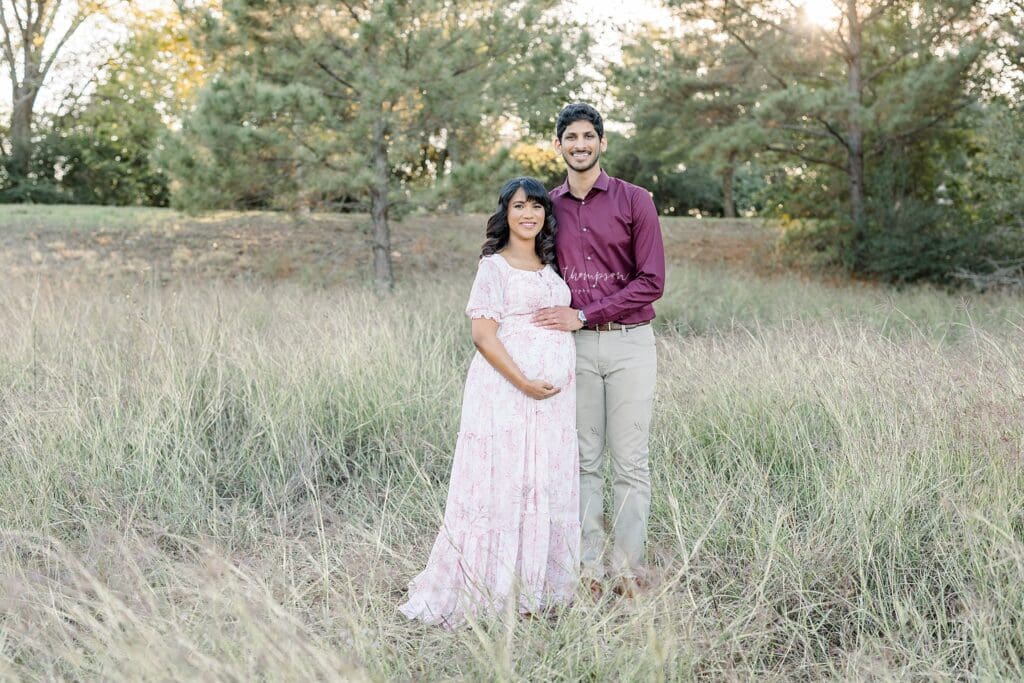 expecting parents smiling during maternity session in katy 