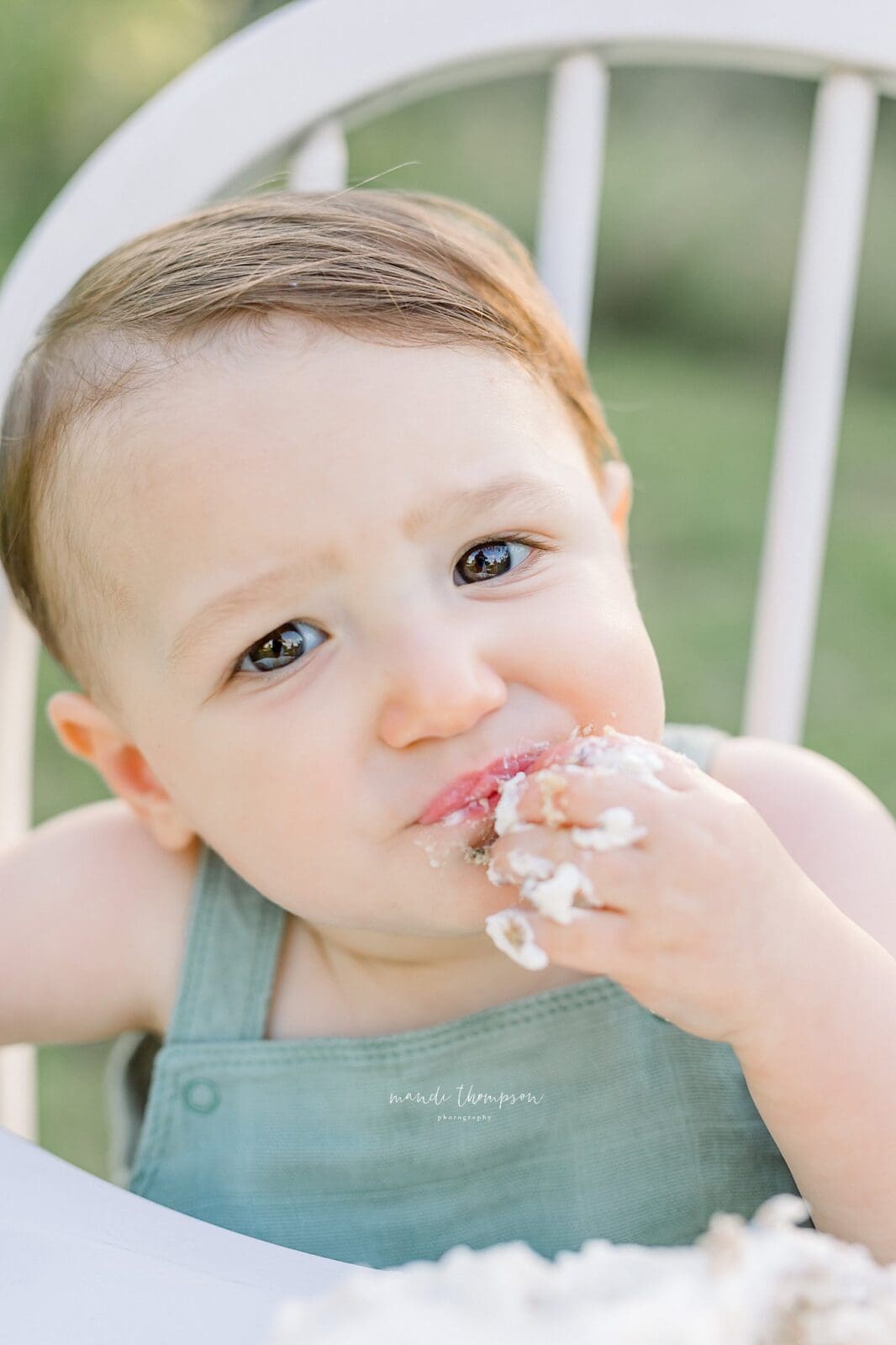One-year-old celebrating with a neutral cake smash